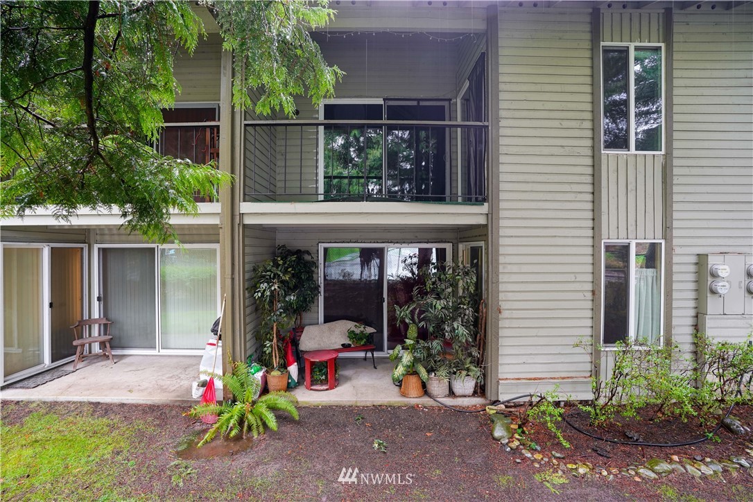 17537 151st Avenue Southeast, Unit 98 Renton, WA 98058 - Photo 19 of 19 a view of a chair and table in the back yard of the house