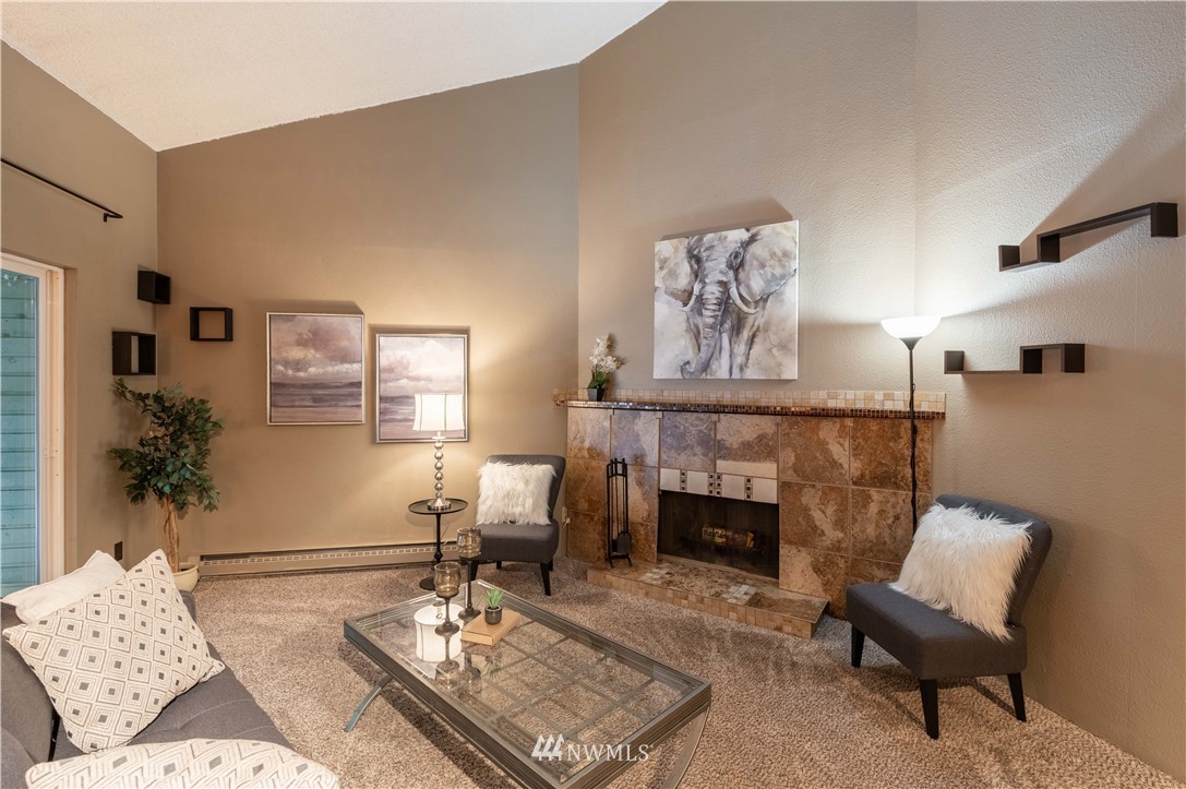 17537 151st Avenue Southeast, Unit 98 Renton, WA 98058 - Photo 3 of 19 a living room with furniture and a fireplace