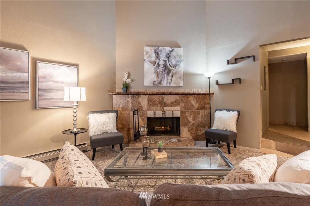 17537 151st Avenue Southeast, Unit 98 Renton, WA 98058 - Photo 4 of 19 a living room with furniture and a fireplace