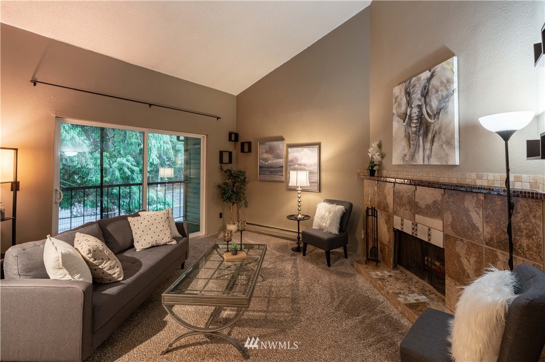 17537 151st Avenue Southeast, Unit 98 Renton, WA 98058 - Photo 6 of 19 a living room with furniture fireplace and a large window