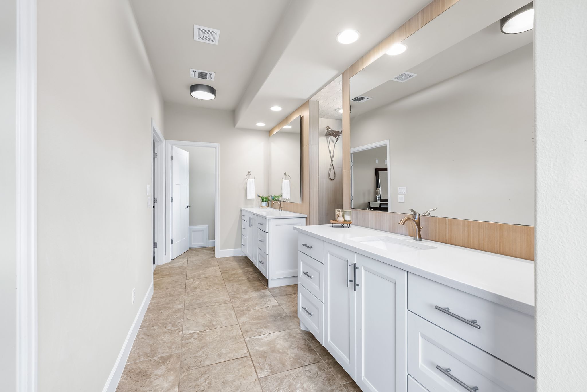 14213 Red Feather Trail Austin, TX 78734 - Photo 20 of 39 a spacious bathroom with a double vanity sink a mirror and a shower