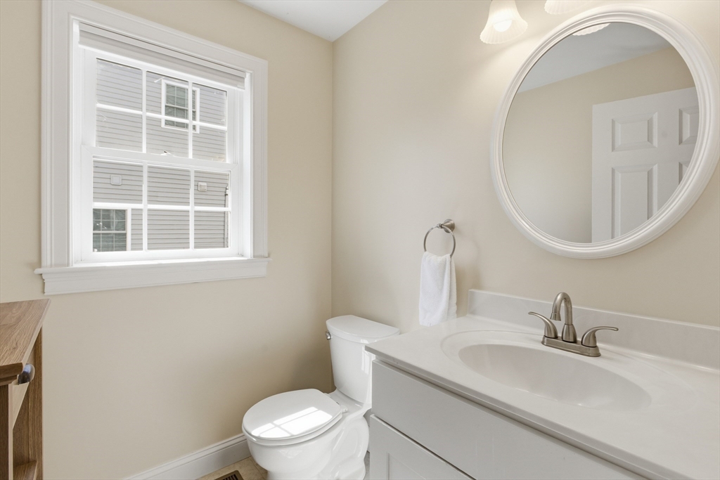 94 Progress Street, Unit 94 Abington, MA 02351 - Photo 12 of 35 a bathroom with a toilet a sink and a mirror