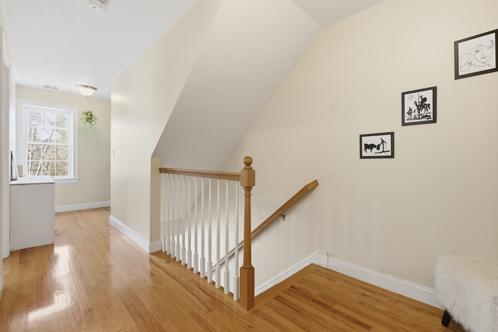 94 Progress Street, Unit 94 Abington, MA 02351 - Photo 13 of 35 a view of a hallway with wooden floor and staircase