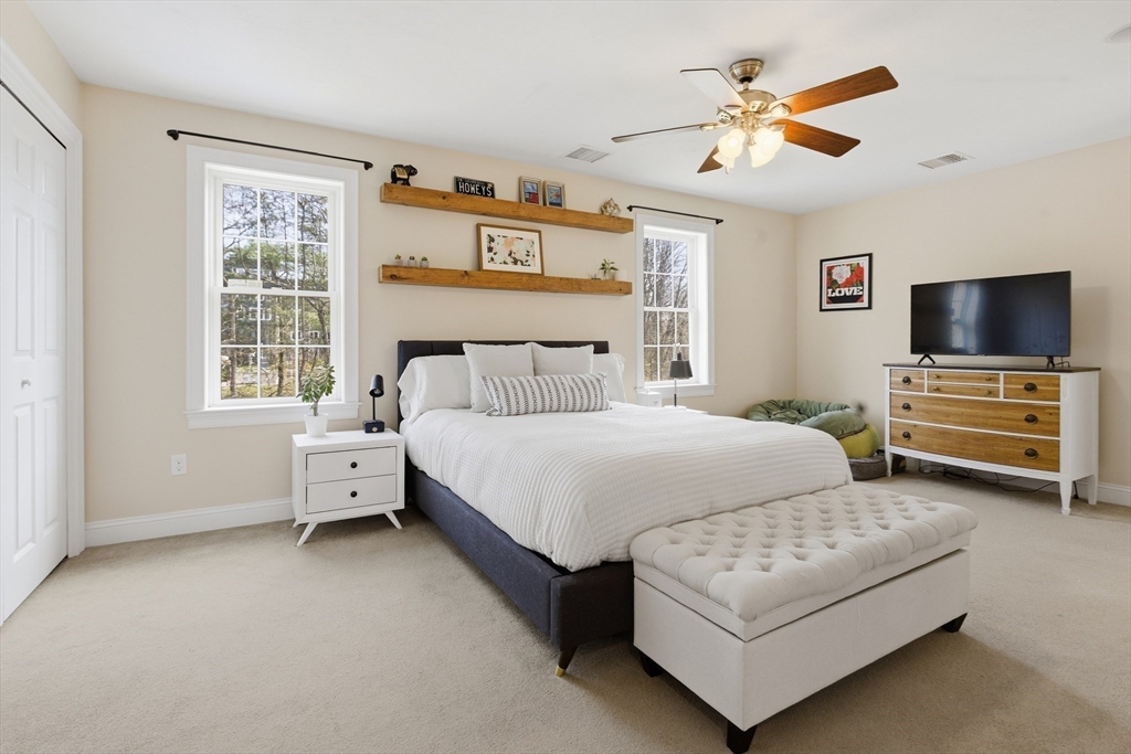 94 Progress Street, Unit 94 Abington, MA 02351 - Photo 14 of 35 a bedroom with a bed a window and a flat screen television