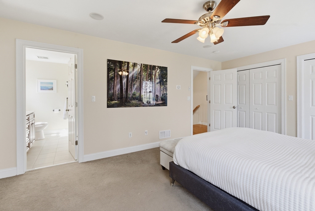 94 Progress Street, Unit 94 Abington, MA 02351 - Photo 17 of 35 a bedroom with a large bed and a chandelier