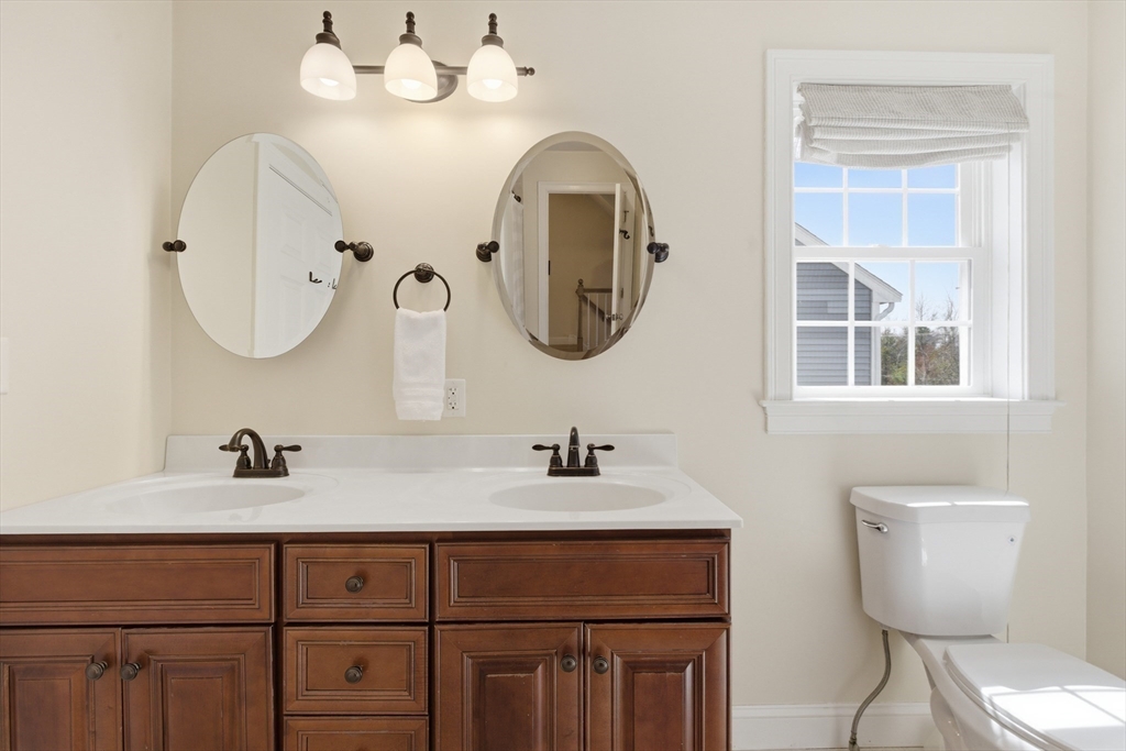 94 Progress Street, Unit 94 Abington, MA 02351 - Photo 20 of 35 a bathroom with a toilet sink and mirror