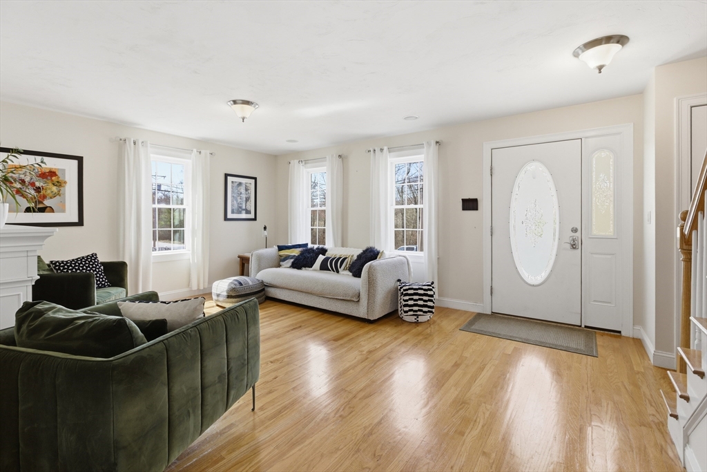 94 Progress Street, Unit 94 Abington, MA 02351 - Photo 2 of 35 a living room with furniture window and wooden floor