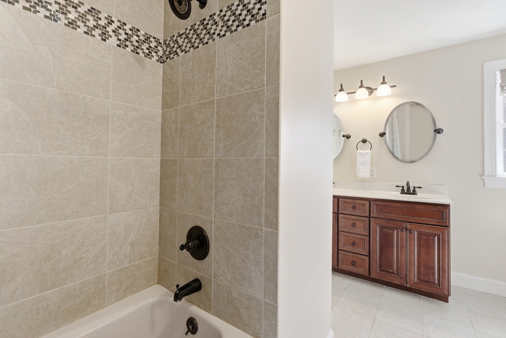 94 Progress Street, Unit 94 Abington, MA 02351 - Photo 21 of 35 a bathroom with a bathtub a sink and a mirror