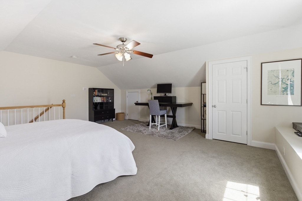 94 Progress Street, Unit 94 Abington, MA 02351 - Photo 25 of 35 a spacious bedroom with a bed and a table in it