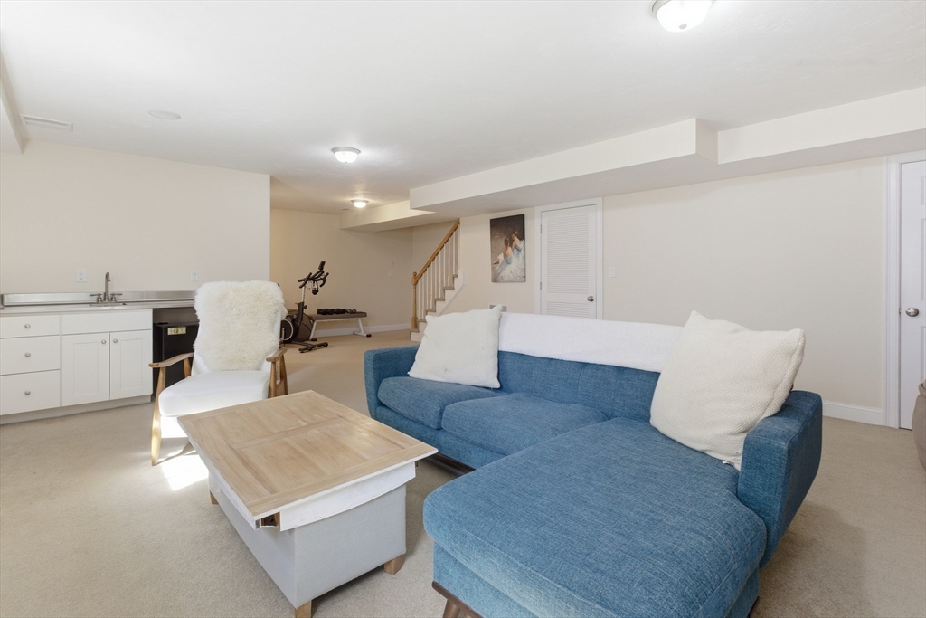 94 Progress Street, Unit 94 Abington, MA 02351 - Photo 28 of 35 a living room with furniture and wooden floor