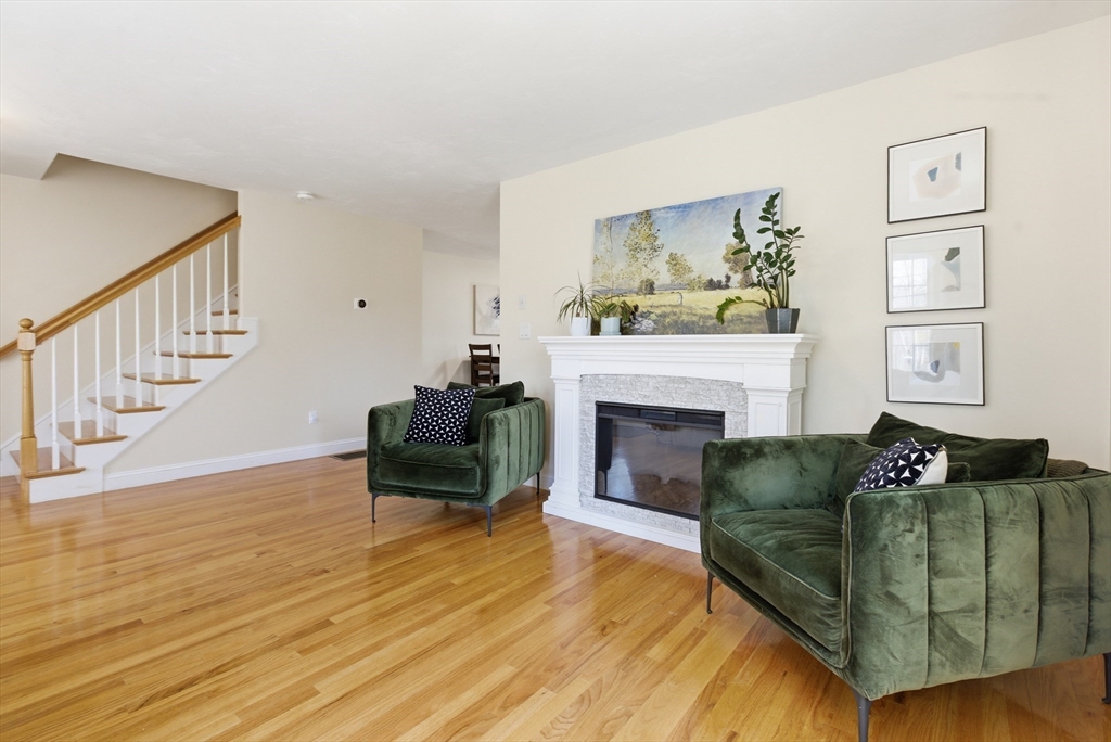 94 Progress Street, Unit 94 Abington, MA 02351 - Photo 3 of 35 a living room with furniture and a fireplace