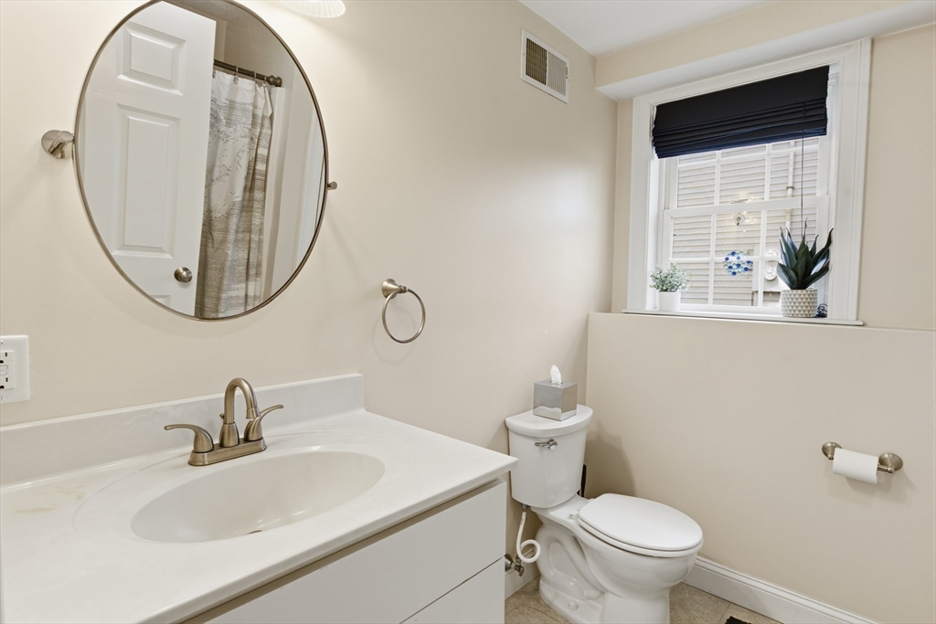 94 Progress Street, Unit 94 Abington, MA 02351 - Photo 32 of 35 a bathroom with a sink a toilet and a mirror