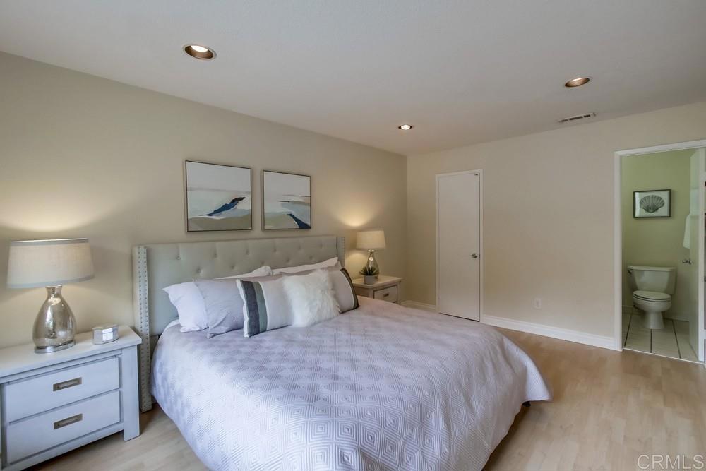12909 Caminito Bodega Del Mar, CA 92014 - Photo 28 of 50 a bedroom with a bed and a night stand