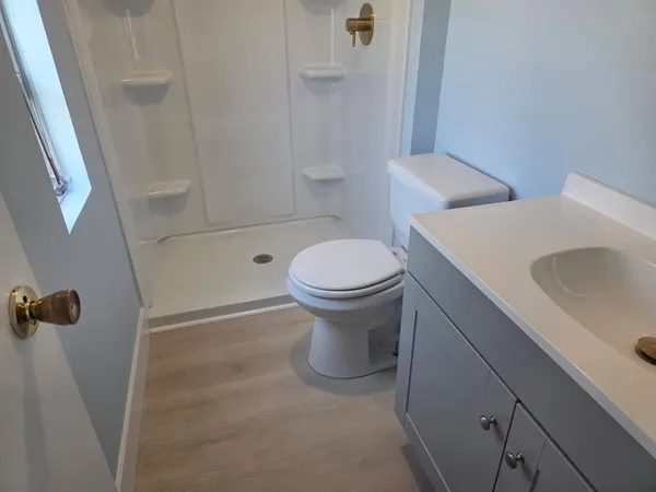 a white toilet sitting next to a bathroom sink