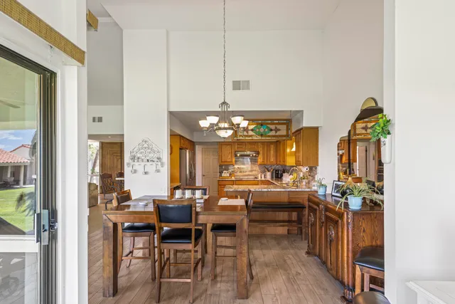 a view of a kitchen with kitchen island dining table and stainless steel appliances