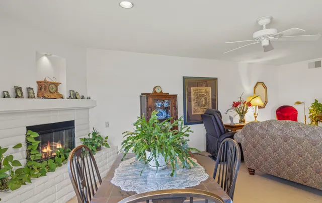 a living room with furniture a rug and a fireplace