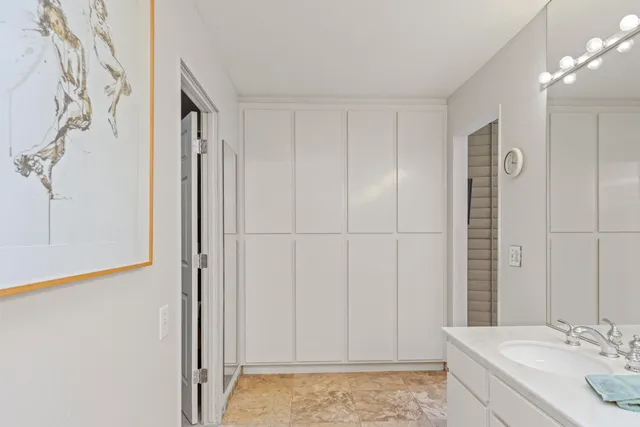 a bedroom with two beds and large window