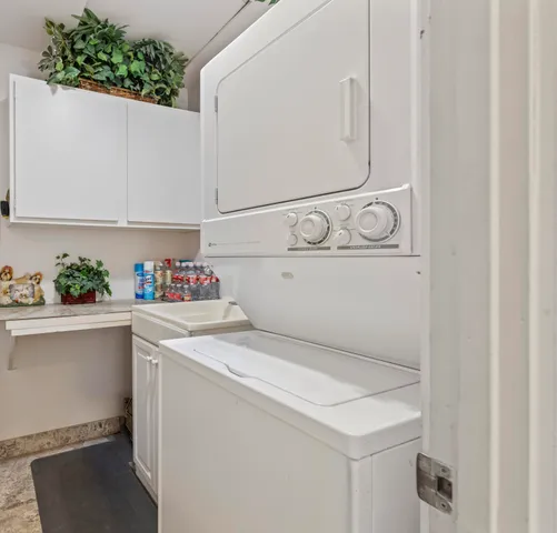 a view of a swimming pool with chair and table in the patio