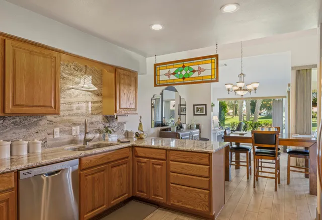 a kitchen with stainless steel appliances granite countertop sink stove and cabinets