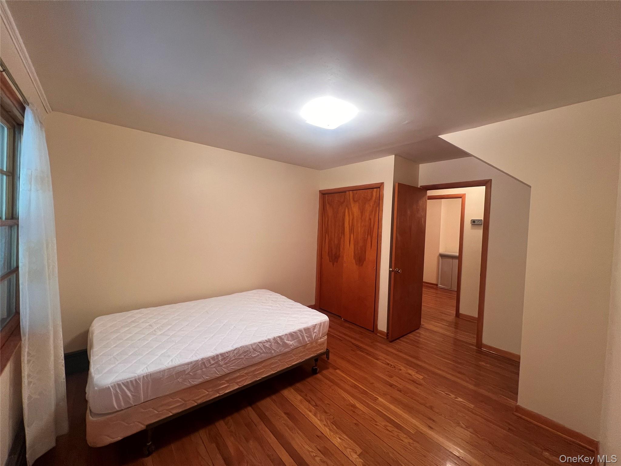 4 Beach Road, Unit G Glen Spey, NY 12737 - Photo 6 of 16 a bedroom with a bed and wooden floor