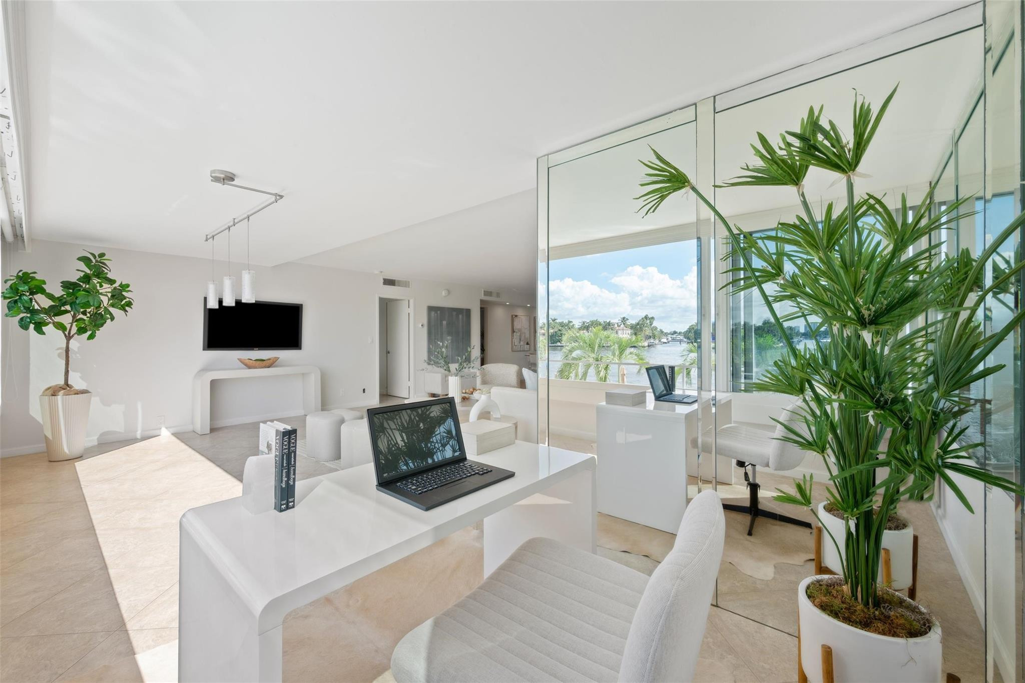 215 North Birch Road, Unit 2B Fort Lauderdale, FL 33304 - Photo 12 of 34 a living room with furniture a large window and a flat screen tv