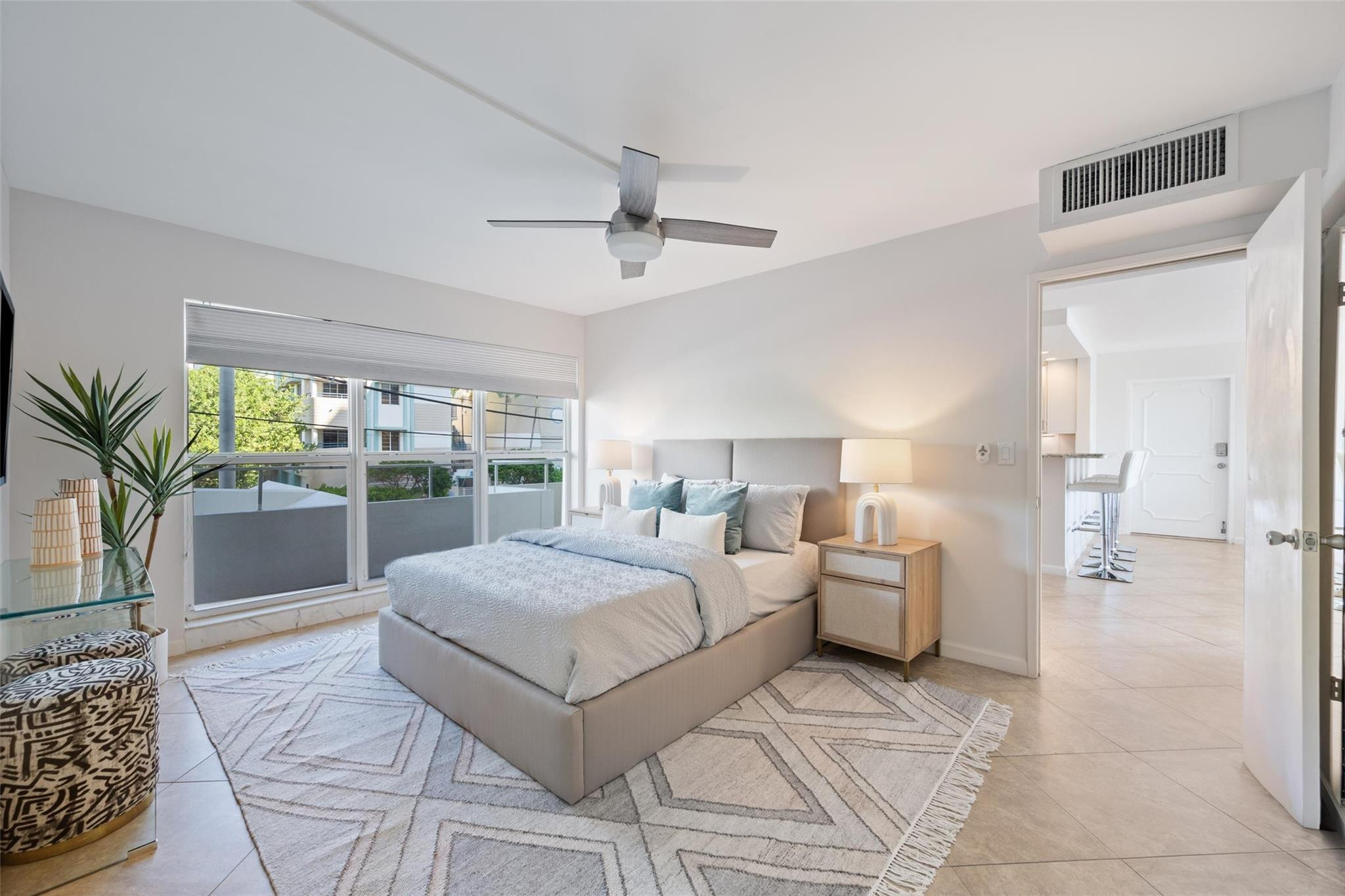 215 North Birch Road, Unit 2B Fort Lauderdale, FL 33304 - Photo 18 of 34 a bedroom with a large bed and a chandelier