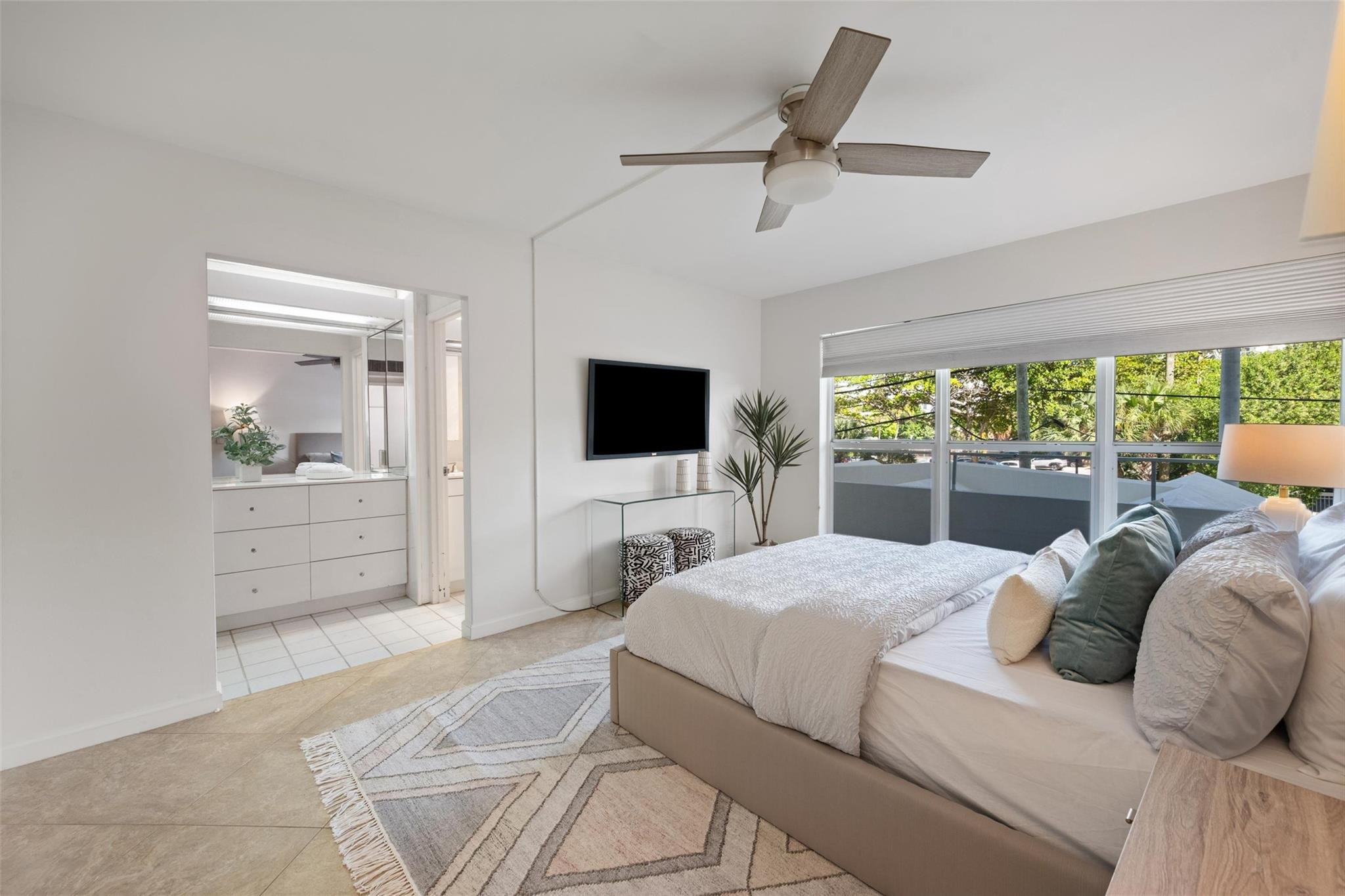 215 North Birch Road, Unit 2B Fort Lauderdale, FL 33304 - Photo 20 of 34 a bedroom with a large bed and a flat screen tv