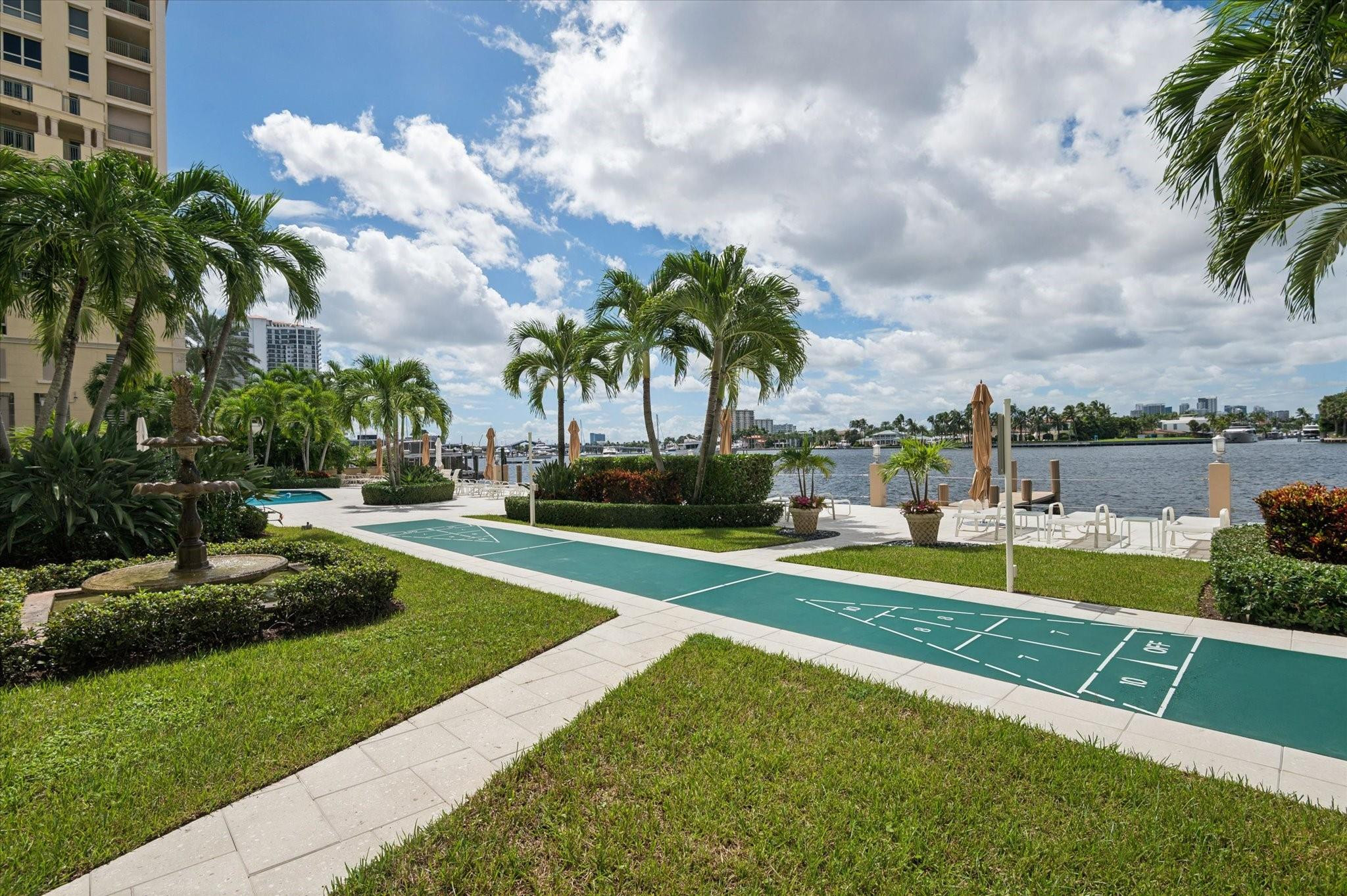 215 North Birch Road, Unit 2B Fort Lauderdale, FL 33304 - Photo 31 of 34 a view of a swimming pool with a garden and plants