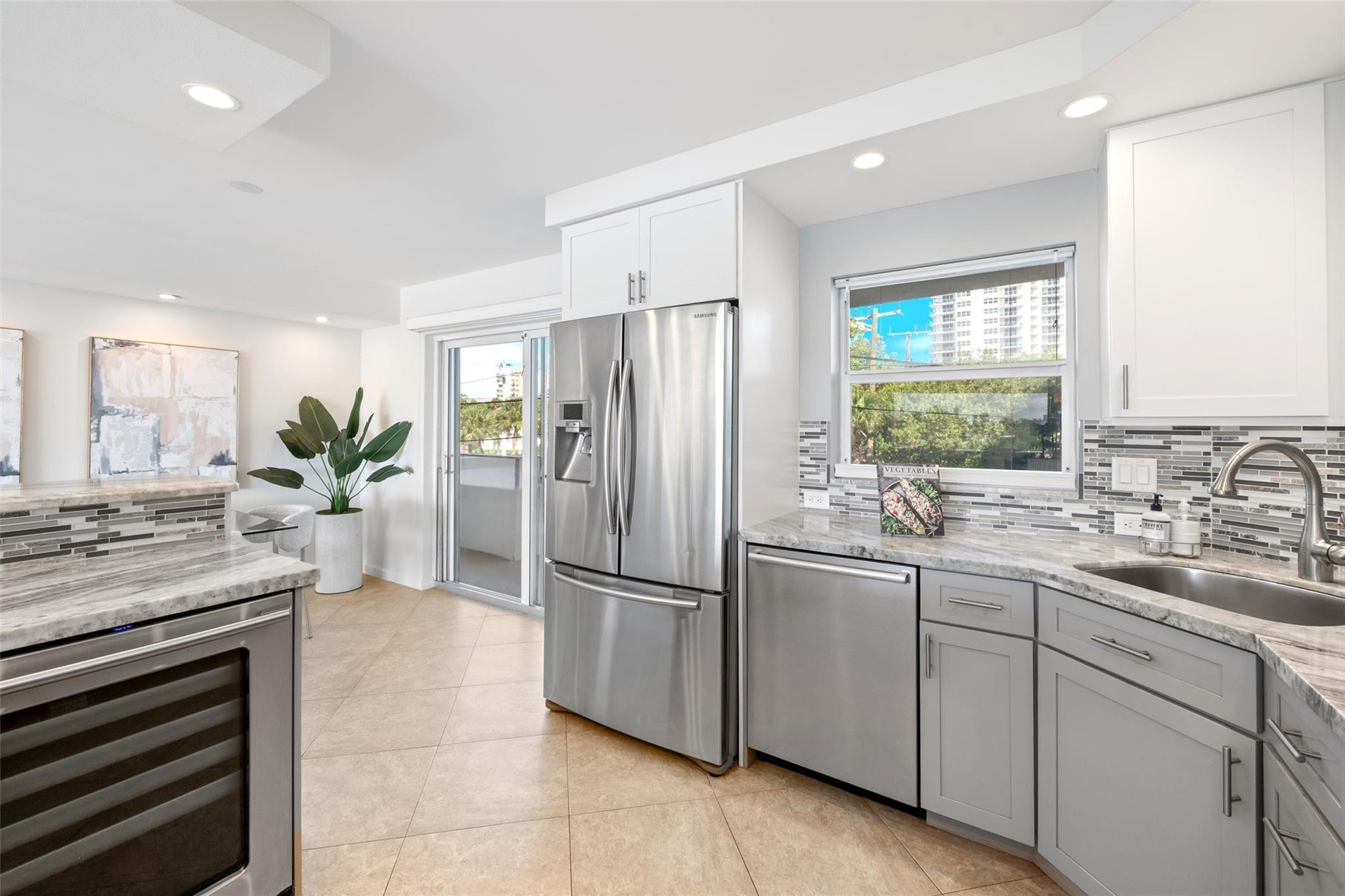 215 North Birch Road, Unit 2B Fort Lauderdale, FL 33304 - Photo 9 of 34 a kitchen with a sink stainless steel appliances and cabinets