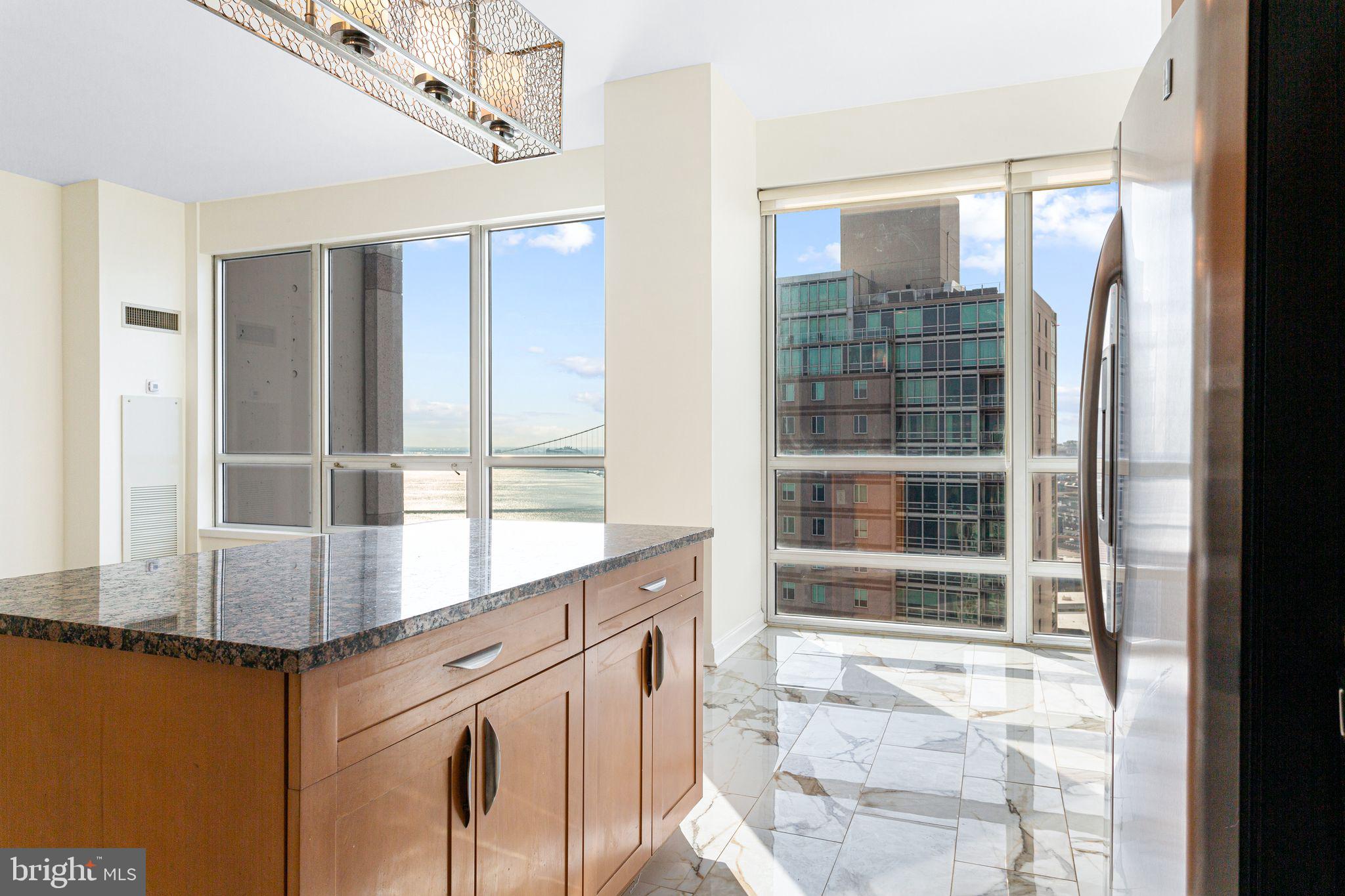 901 North Penn Street, Unit R2203 Philadelphia, PA 19123 - Photo 11 of 58 a view of a kitchen with a sink and windows