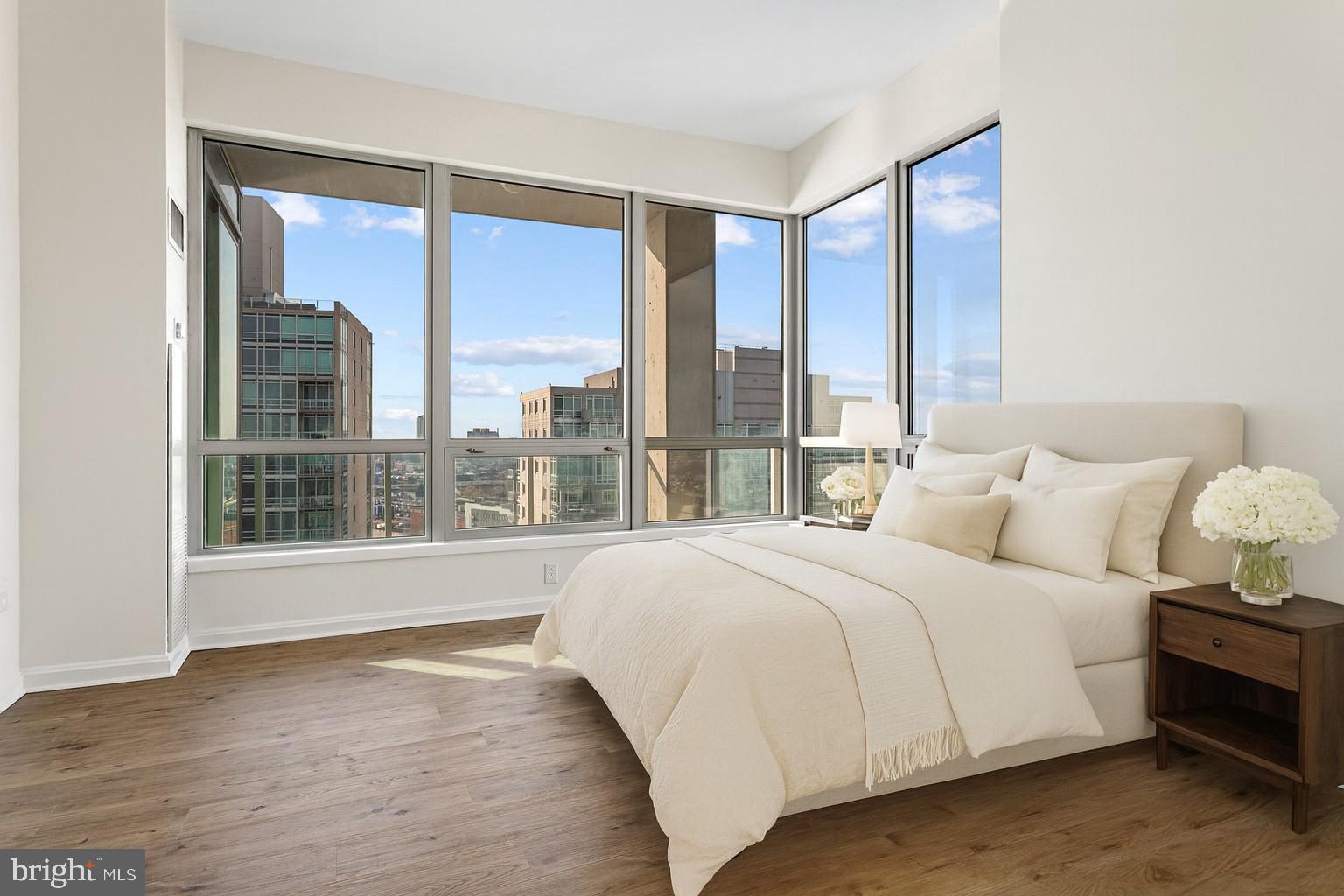 901 North Penn Street, Unit R2203 Philadelphia, PA 19123 - Photo 15 of 58 a large bedroom with a large bed and a large window