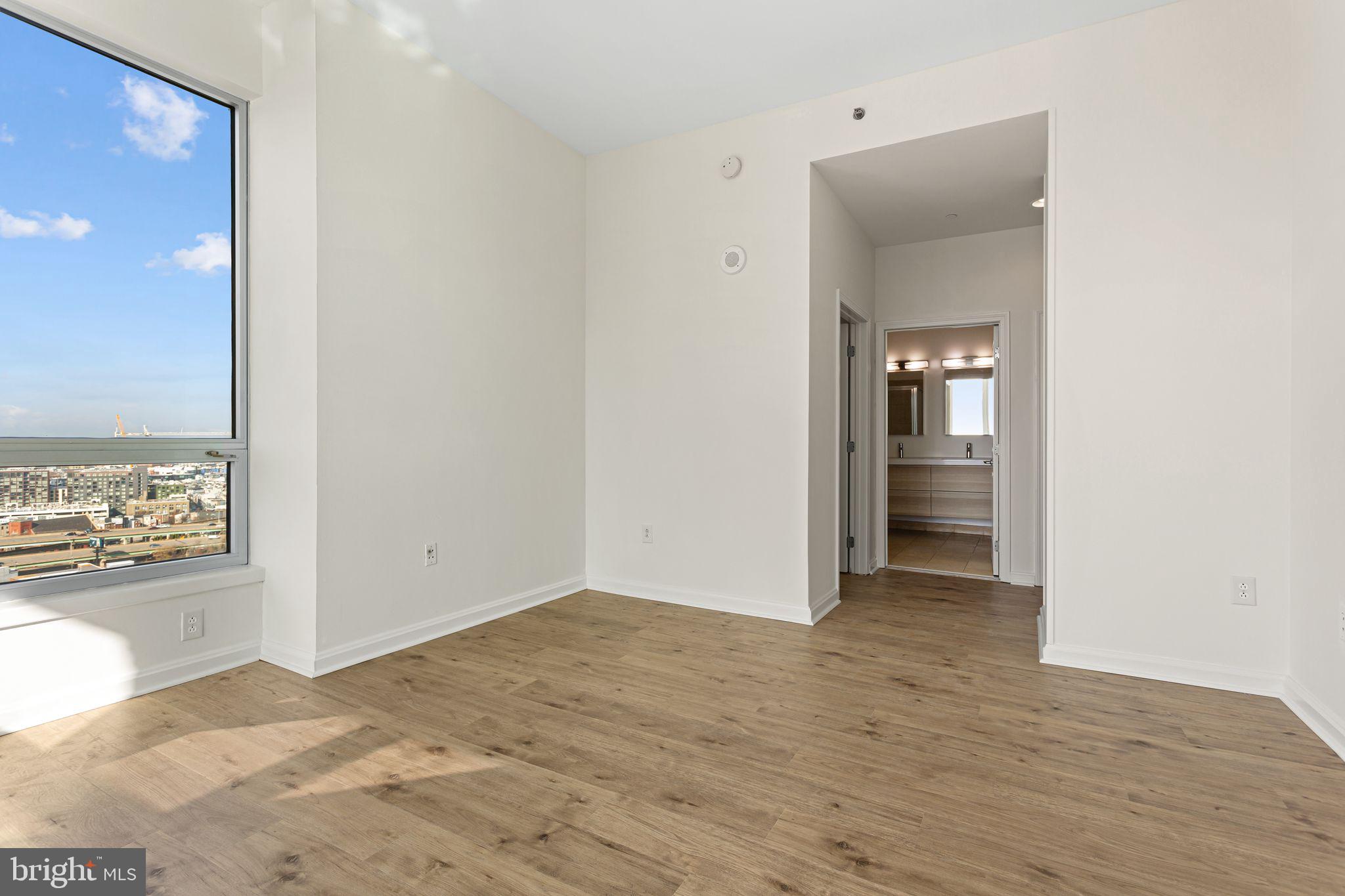 901 North Penn Street, Unit R2203 Philadelphia, PA 19123 - Photo 18 of 58 a view of a hallway with wooden floor and a bathroom