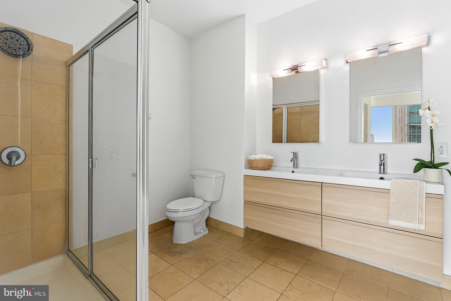 901 North Penn Street, Unit R2203 Philadelphia, PA 19123 - Photo 19 of 58 a bathroom with a toilet sink and a mirror