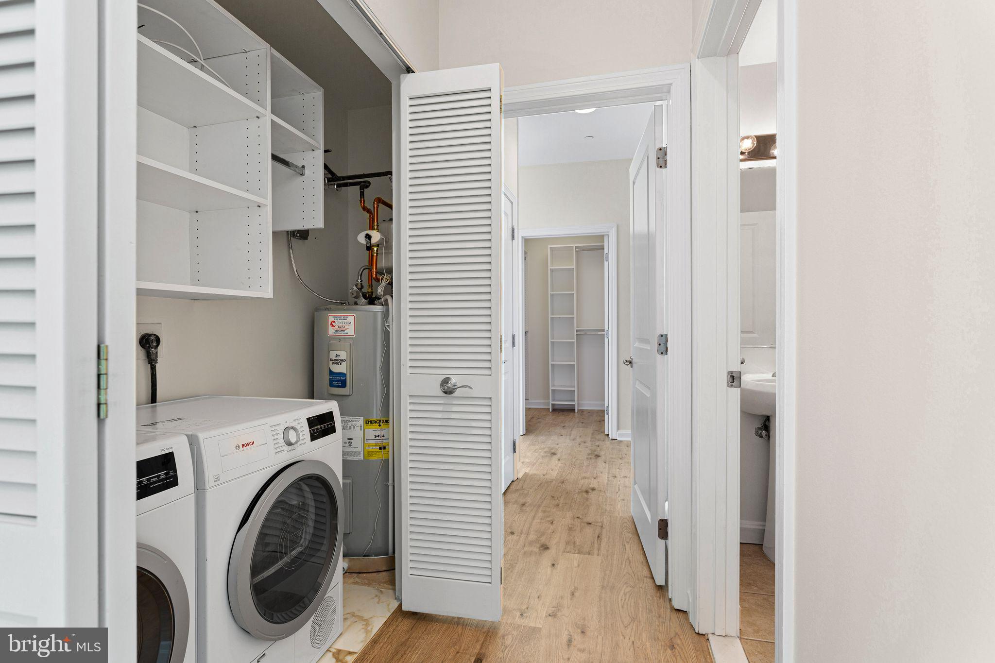 901 North Penn Street, Unit R2203 Philadelphia, PA 19123 - Photo 23 of 58 a view of a hallway with washer and dryer