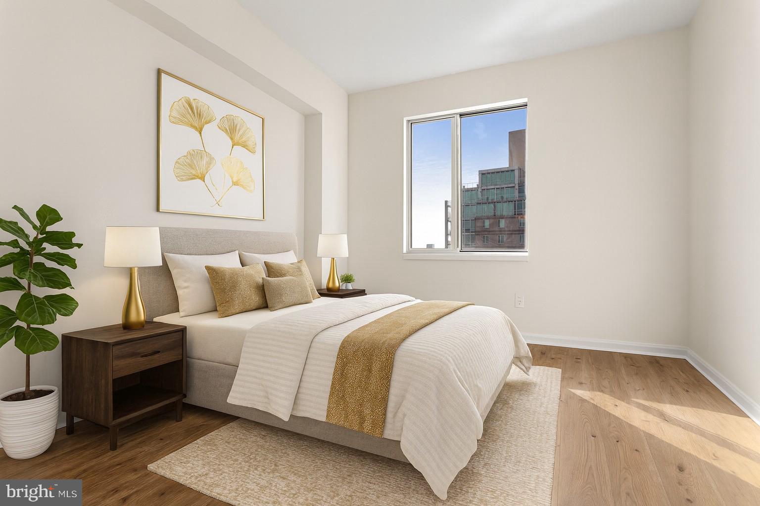 901 North Penn Street, Unit R2203 Philadelphia, PA 19123 - Photo 25 of 58 a bedroom with a bed and a potted plant on the dresser
