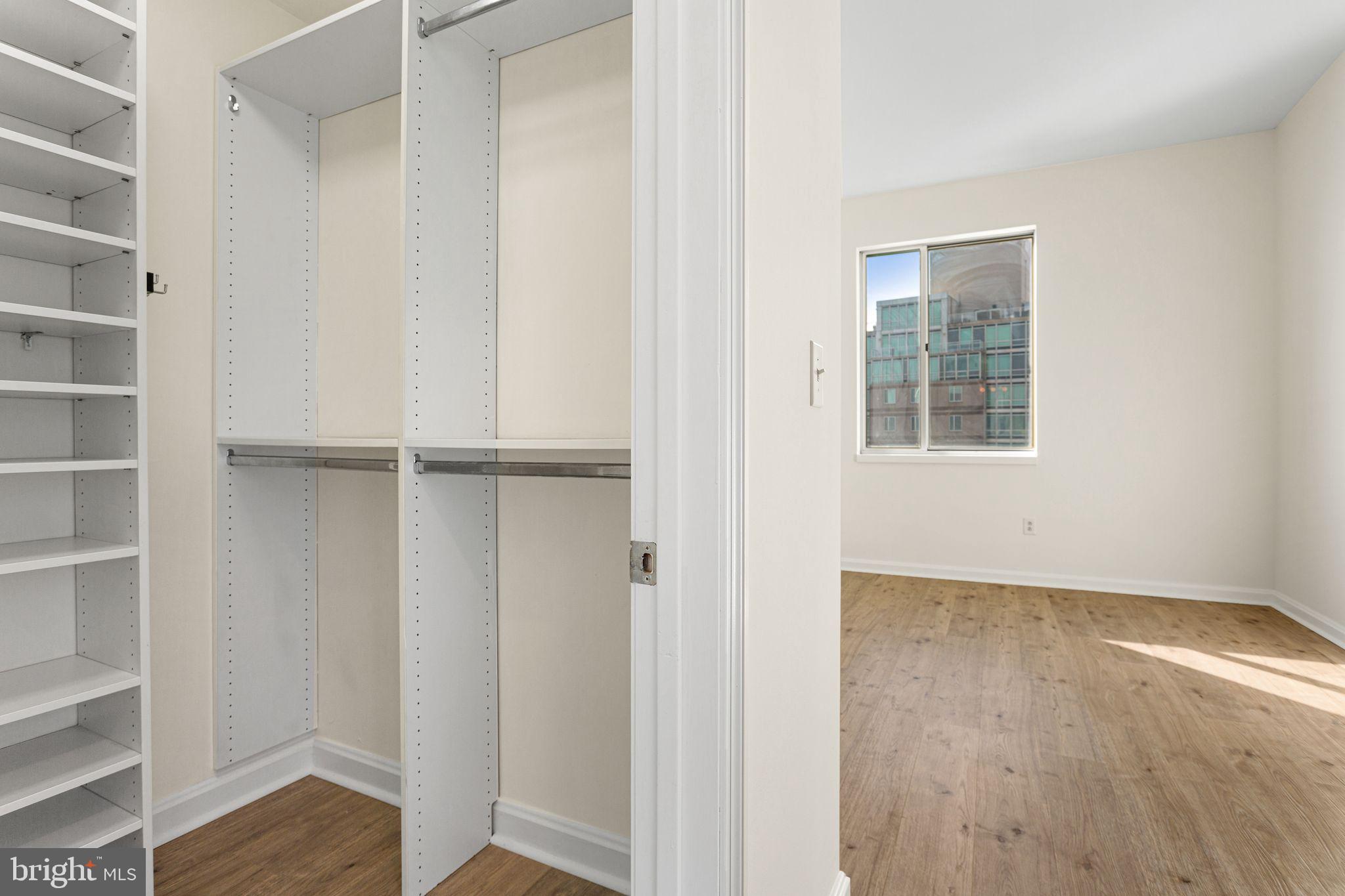 901 North Penn Street, Unit R2203 Philadelphia, PA 19123 - Photo 28 of 58 a view of an empty room with wooden floor and a window