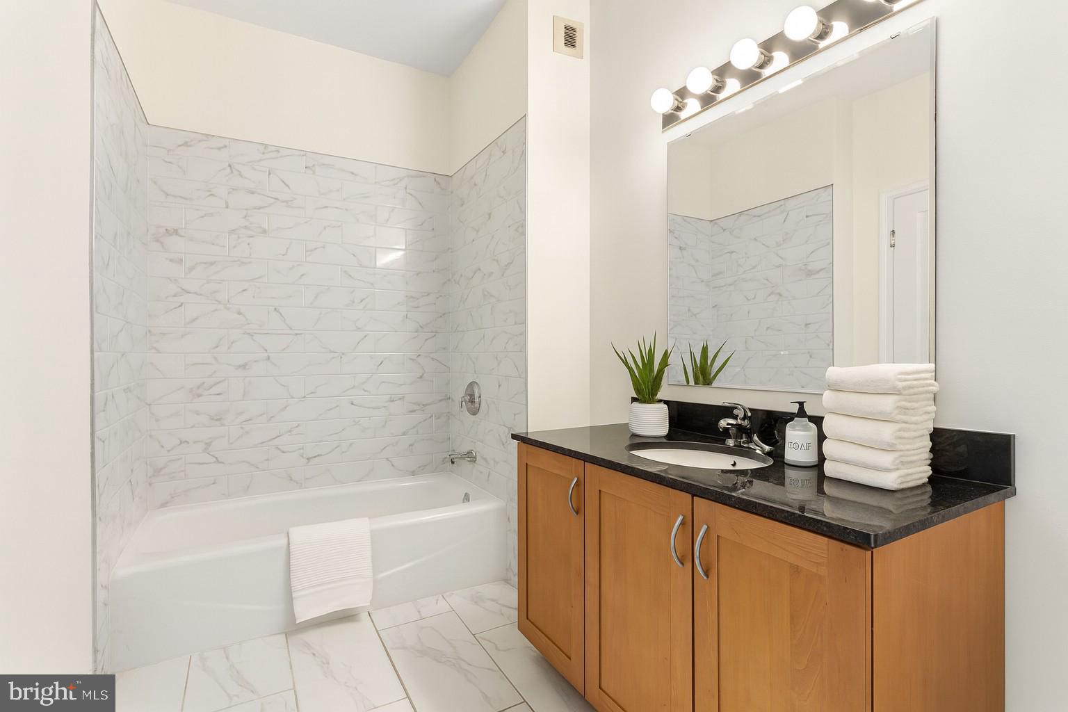 901 North Penn Street, Unit R2203 Philadelphia, PA 19123 - Photo 29 of 58 a bath room with a sink and a bath tub