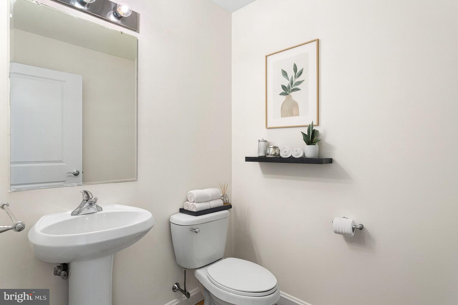 901 North Penn Street, Unit R2203 Philadelphia, PA 19123 - Photo 34 of 58 a bathroom with a toilet sink and mirror