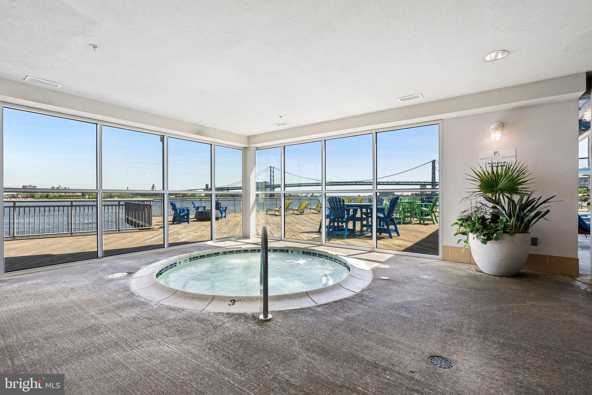 901 North Penn Street, Unit R2203 Philadelphia, PA 19123 - Photo 44 of 58 a view of a livingroom with a floor to ceiling window and kitchen