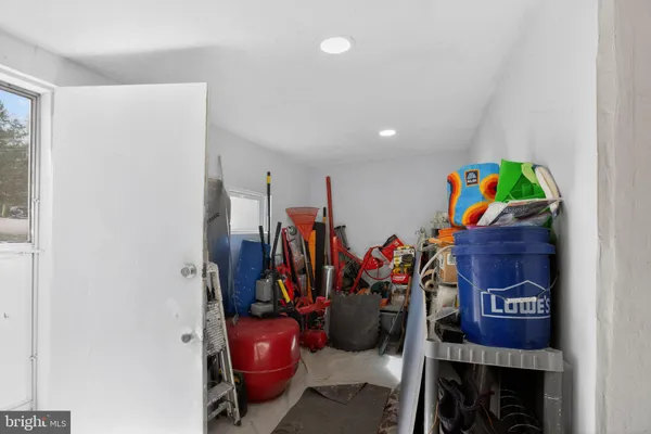 a living room with a couch and a dining table with wooden floor