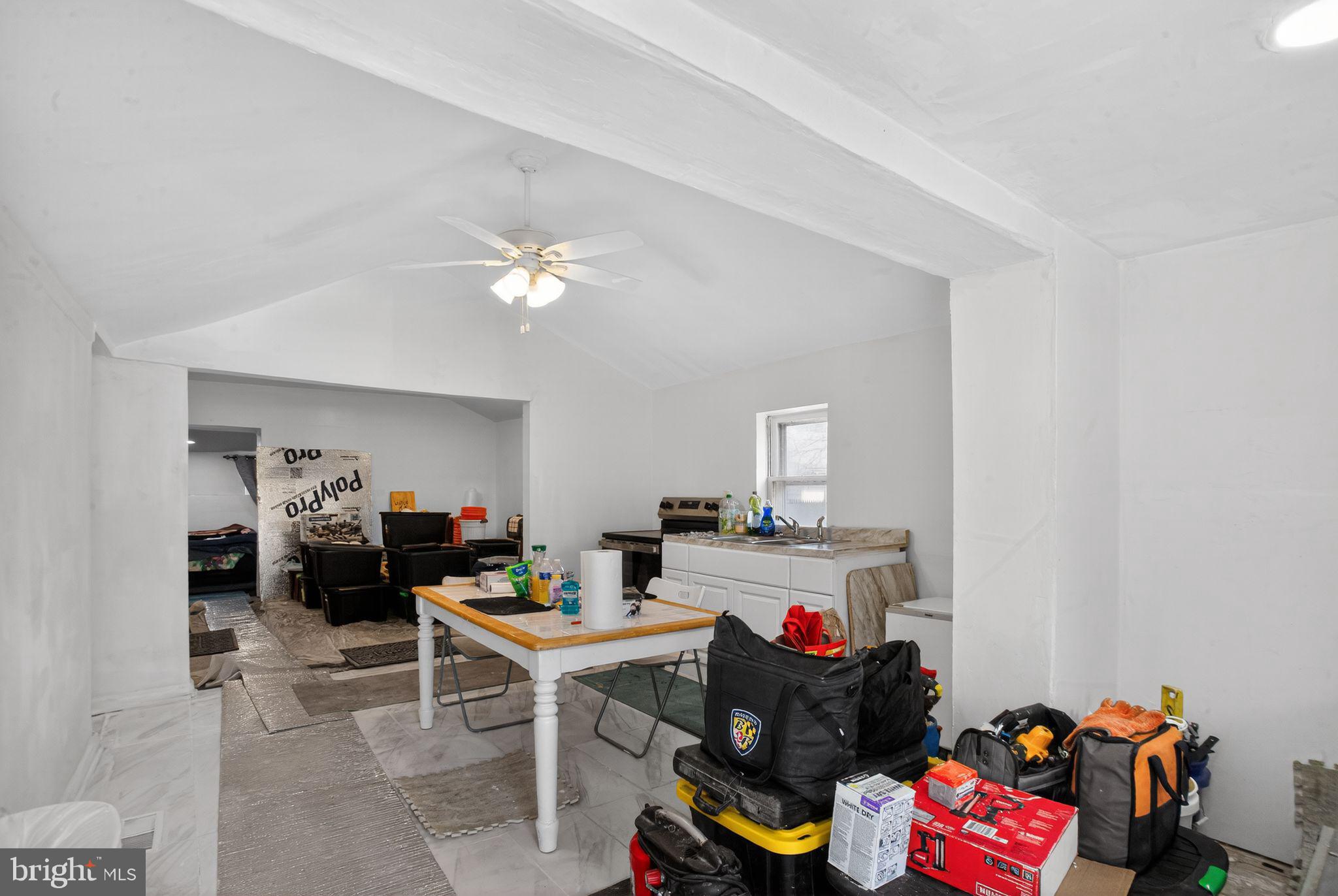 259 Shoemaker Lane Bridgeton, NJ 08302 - Photo 8 of 23 a living room with a couch and a dining table with wooden floor