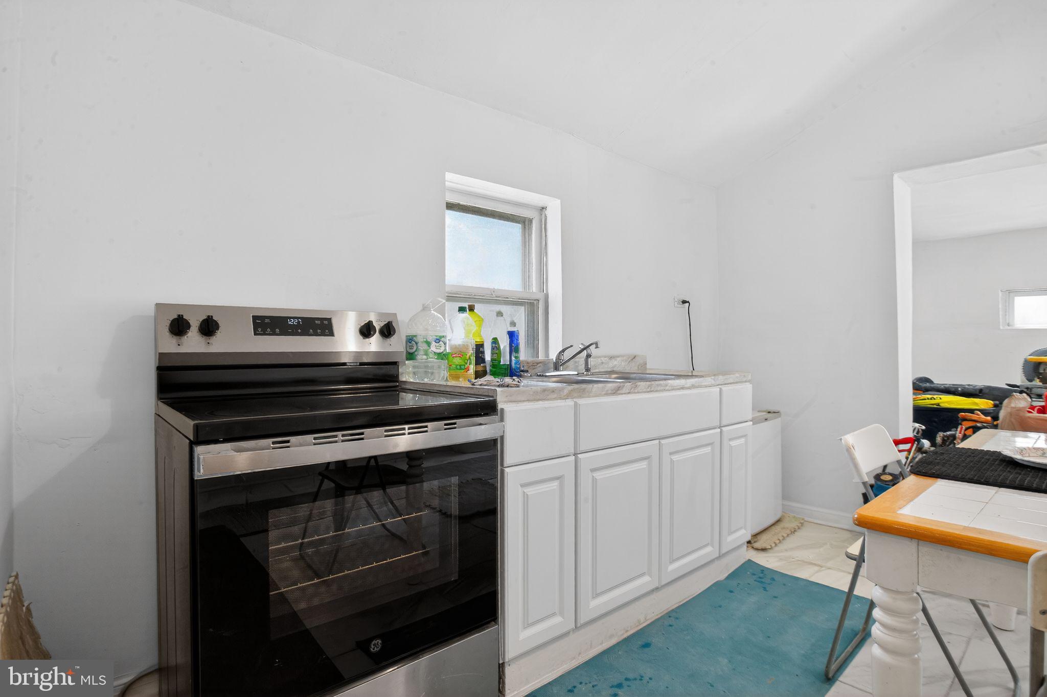 259 Shoemaker Lane Bridgeton, NJ 08302 - Photo 9 of 23 a kitchen with stainless steel appliances a stove a sink and a refrigerator