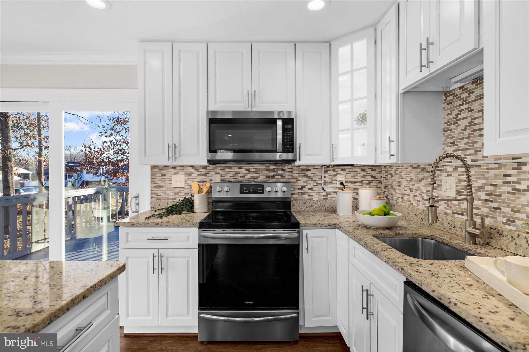 9008 Townsend Lane Clinton, MD 20735 - Photo 11 of 48 a kitchen with granite countertop a sink stove and microwave
