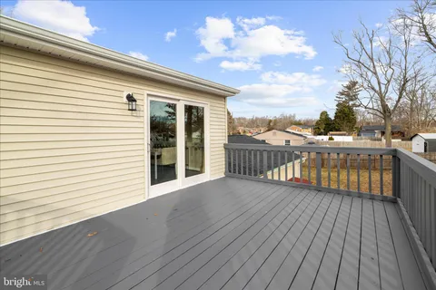 a view of city balcony with wooden floor