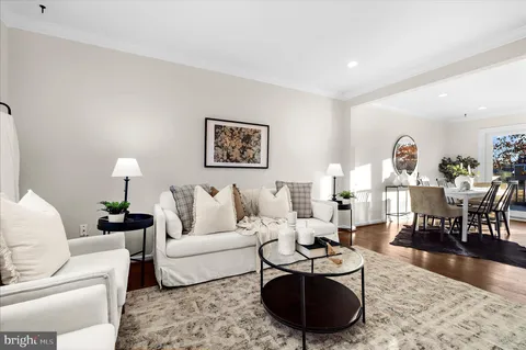 a living room with furniture a rug and a table