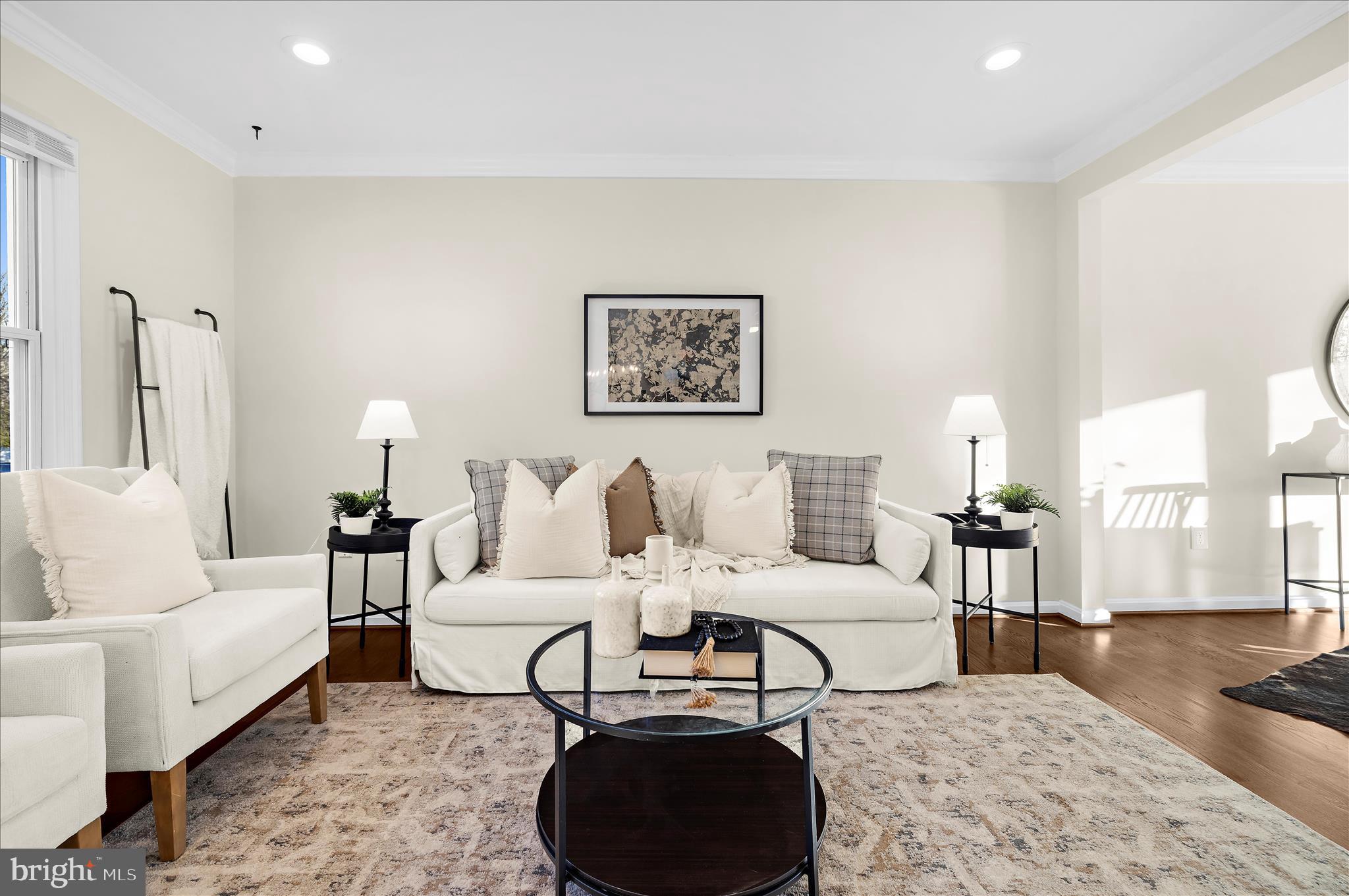 9008 Townsend Lane Clinton, MD 20735 - Photo 5 of 48 a spacious bedroom with a bed a couch and large windows