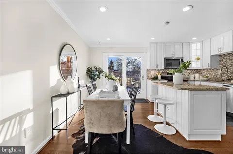 a spacious bedroom with a bed a couch and large windows