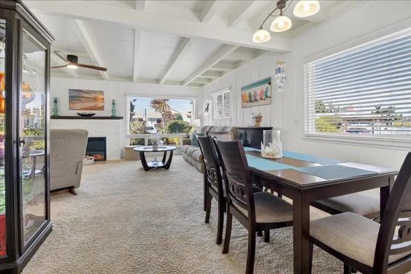 a dining room with a wooden table and chairs