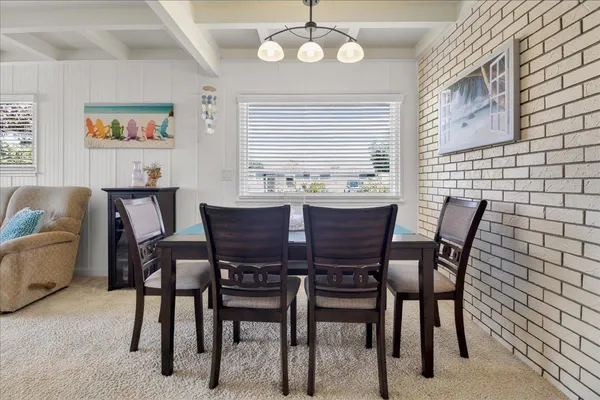 a view of a dining room with furniture and a large window