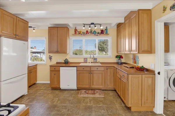 a kitchen with a sink stove and refrigerator